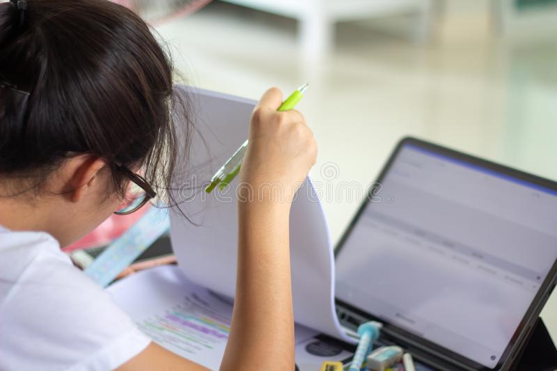 young-concentrated-woman-reading-text-book-using-tablet-research-internet-online-data-school-exam-asian-girl-student-study-156919391.jpg